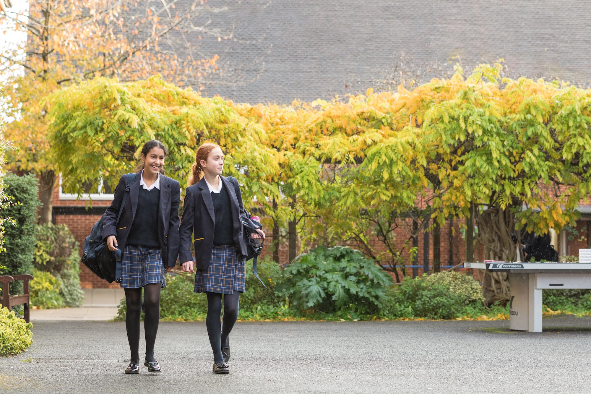 Two senior school students walking through co-education court yard